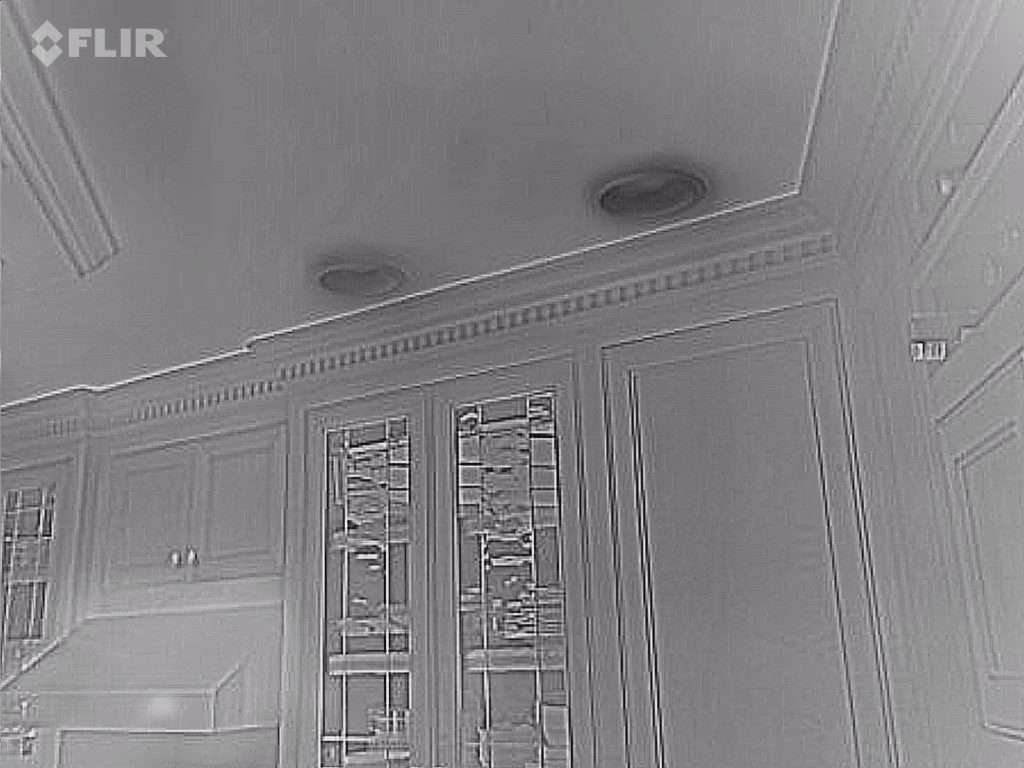 Infrared camera image showing cold air infiltration around recessed light fixtures in Wisconsin home